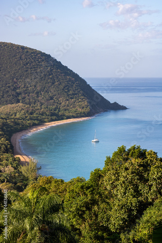 Guadeloupe, a Caribbean island in the French Antilles. View of the sandy beach of Guadeloupe. Caribbean vacation landscape. Grande Anse beach on the island of Basse-Terre. A secluded bay.