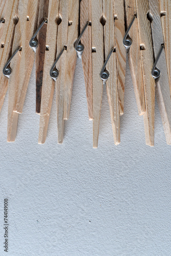 closeup on top view of wooden clothespins on white background