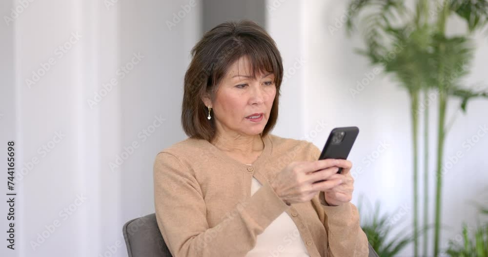 Attractive female worker texting business documents using mobile smartphone sitting in office plants white wall background. Attractive female worker texting business documents using mobile smartphone sitting in office plants white wall background.