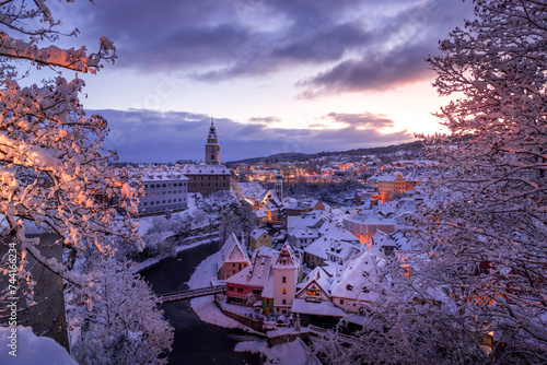Winter view of Cesky Krumlov, picturesque houses under the castle with snow-covered roofs. Narrow streets and the Vltava river. Travel and Holiday. Christmas time. UNESCO World Heritage. Czechia