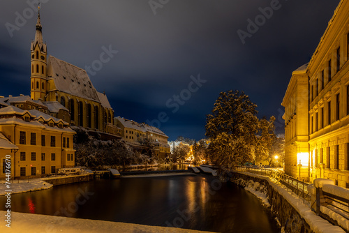 Winter view of Cesky Krumlov, picturesque houses under the castle with snow-covered roofs. Narrow streets and the Vltava river. Travel and Holiday. Christmas time. UNESCO World Heritage. Czechia