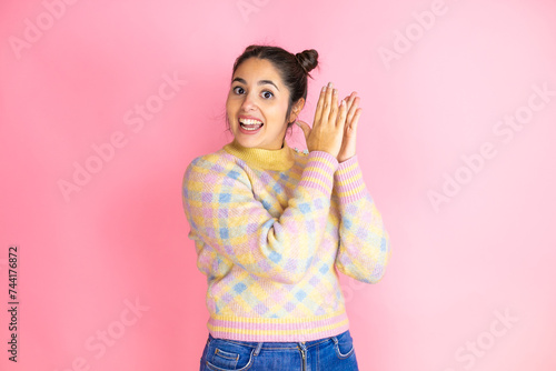Young beautiful woman wearing casual sweater over isolated pink background clapping and applauding happy and joyful, smiling proud hands together