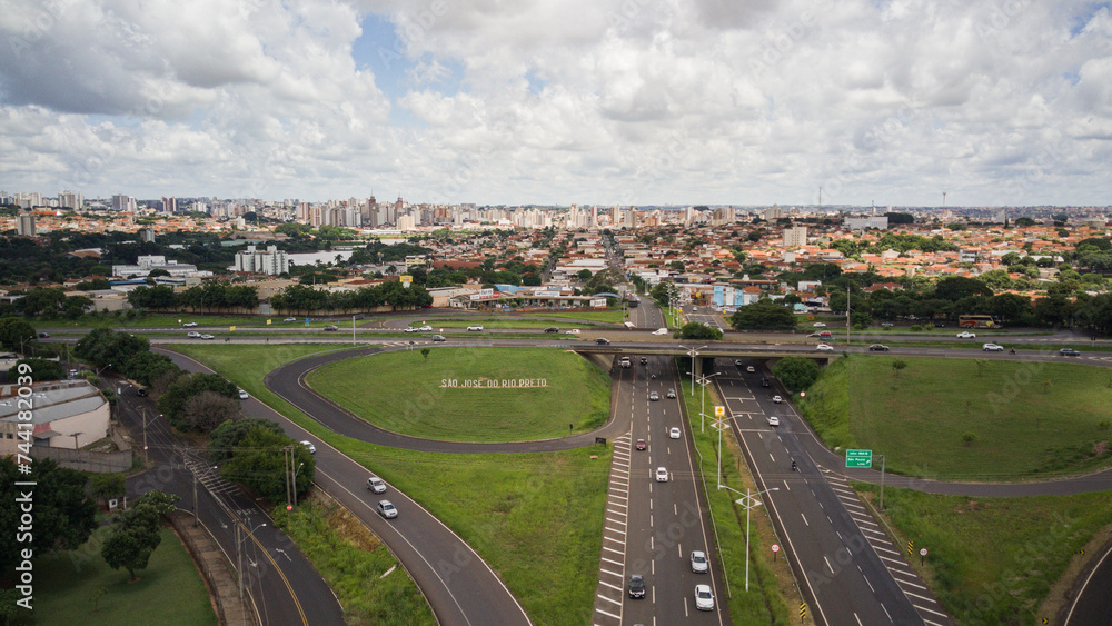 Aerial drone view of the entrance to the city of São José do Rio Preto, in Brazil, with the roads in the foreground and the city in the background, with the sign in evidence