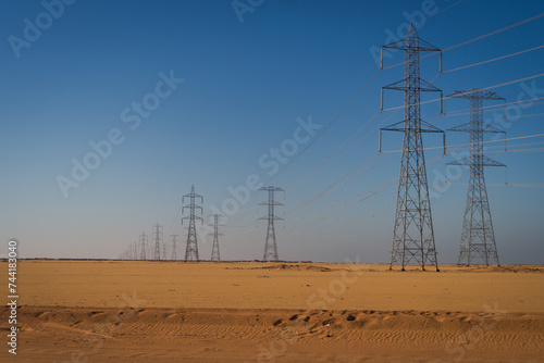 electric power generated  from the Answan Dam along the desert heading south in Egypt 
