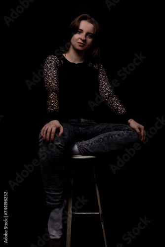Portrait of a beautiful girl on a black background