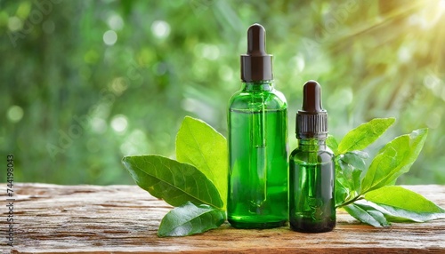 green cosmetic product bottles with serum and moisturizing essential oil with herbal leaves