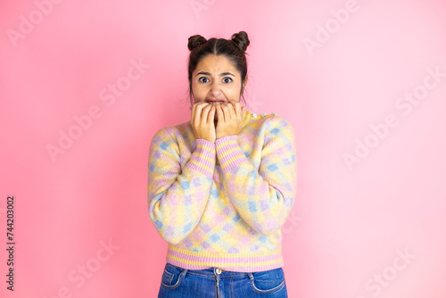 Fotografija Young beautiful woman wearing casual sweater over isolated yellow background looking stressed and nervous with hands on mouth biting nails