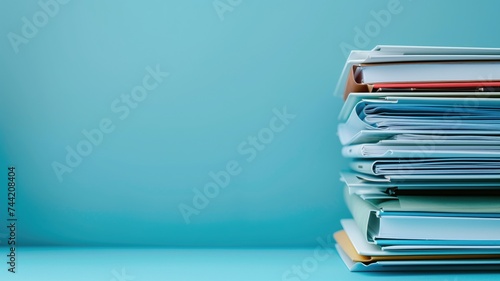 Stack of folders on a light blue background photo
