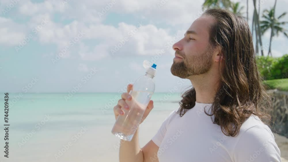 Handsome male tourist with light unshaveness enjoying vacation on the beach of Hawaii gazing at aquamarine waters of the Pacific ocean and vast horizon. High quality 4k footage Handsome male tourist with light unshaveness enjoying vacation on the beach of Hawaii gazing at aquamarine waters of the Pacific ocean and vast horizon. High quality 4k footage