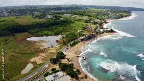Aerial slow-motion of Penon Amador Beach on a sunny day in Camuy, Puerto Rico photo
