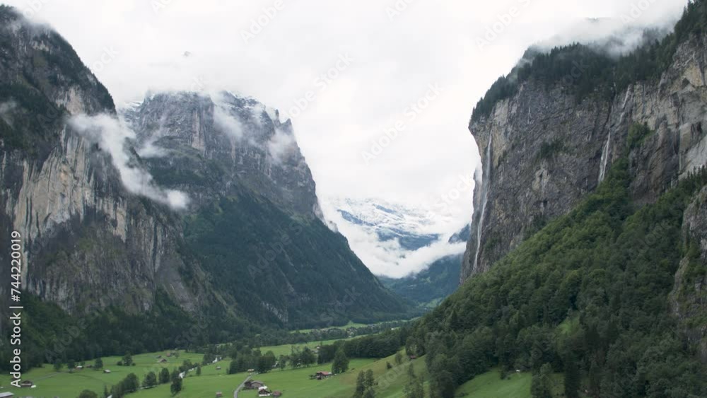 Beautiful view of green valley and misty mountains of Switzerland Beautiful view of green valley and misty mountains of Switzerland