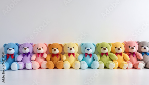 row of plush toys neatly lined up together on white background 