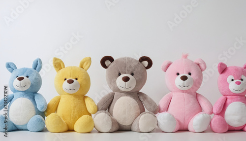row of plush toys neatly lined up together on white background 