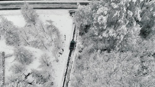 Drone footage of car driving in the winter forest road. Landvetter, Sweden photo