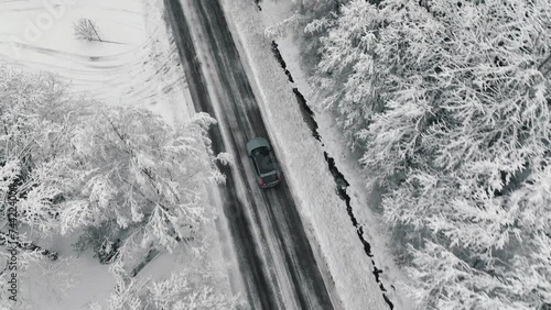 Drone footage of car driving in the winter forest road. Landvetter, Sweden photo