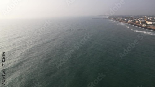 Aerial video of Puducherry sea shore with cinematic view of bay of bengal. Formerly known as Pondicherry City. Early morning sky and sea. photo