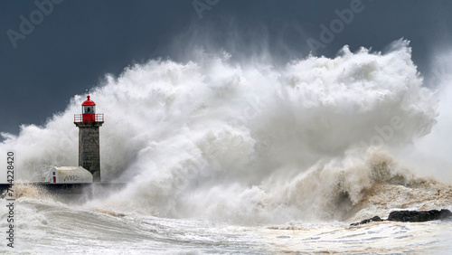 Lighthouse and large oceanic wave in a storm, Porto, Portugal