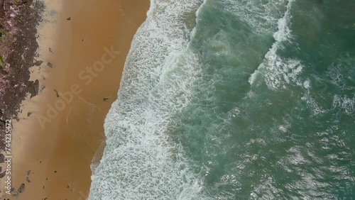 The crashing waves hitting Pipa Beach can be seen from an aerial view. (Praia da Pipa, Brazil). photo