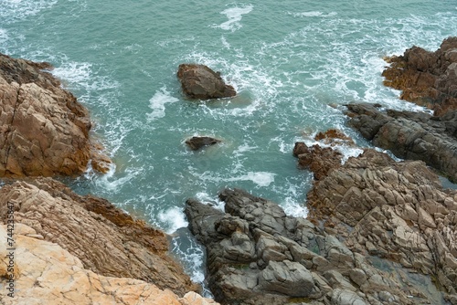 Stunning seascape featuring a rocky coastline with waves crashing against the rocky terrain