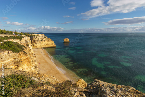 Golden rock cliffs at the coastline of the Atlantic Ocean with beach Praia da Marinha near the Cave of Benagil, Algarve, Portugal
