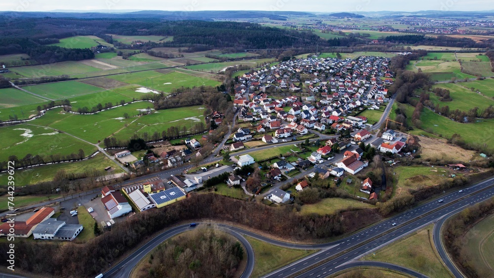 Aerial around the village Löschenrod in Germany on a cloudy day in late summer