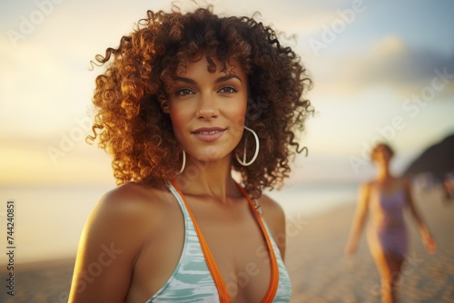 Portrait of a fit and attractive young woman smiling on the beach © CarpathiaProductions