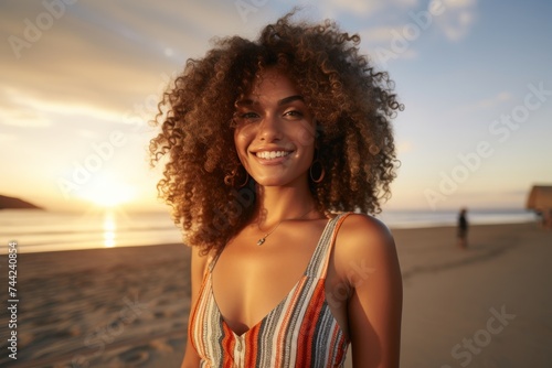 Portrait of a fit and attractive young woman smiling on the beach