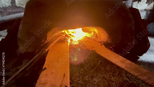 someone cooks using a firewood stove