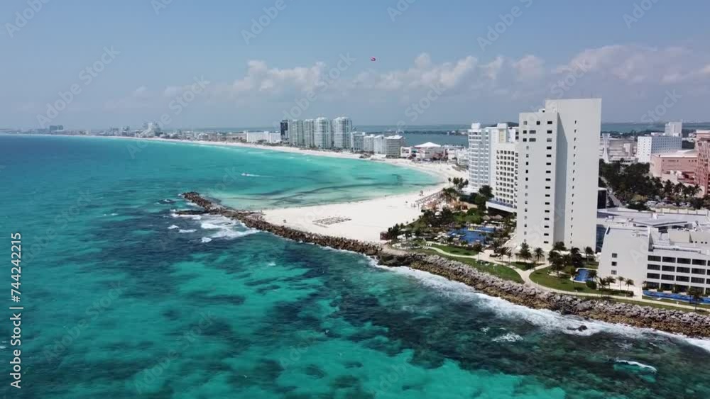 Cancun coastline with turquoise waters and beachfront hotels, sunny day, aerial view Cancun coastline with turquoise waters and beachfront hotels, sunny day, aerial view