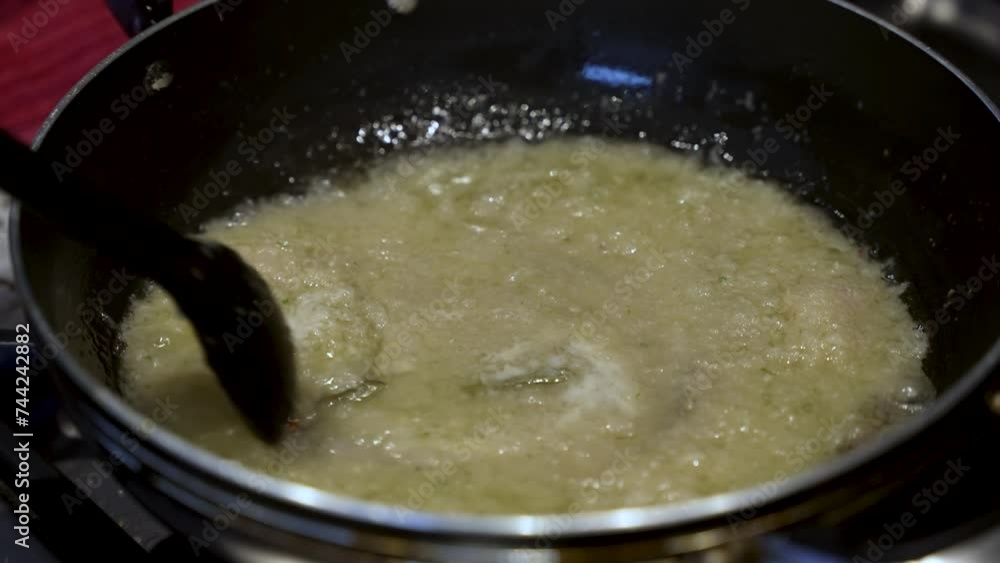 Spoon Stirring Simmering Onions In Pan, evoking the essence of cooking mastery and meticulous food preparation. Slow Motion Spoon Stirring Simmering Onions In Pan, evoking the essence of cooking mastery and meticulous food preparation. Slow Motion