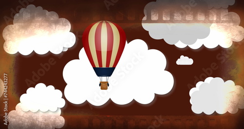 Image of clouds and hot air balloon over grey background