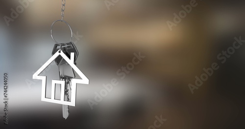 Image of silver house keys and house shaped key fob hanging over out of focus background 4k