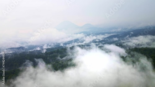 Wallpaper Mural aerial footage above a vibrant rainforest with an active volcano in the backdrop, highlighting conservation efforts, aerial 4k drone footage Torontodigital.ca