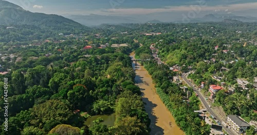 Peradeniya Sri Lanka Aerial v1 drone fly along Mahaweli river capturing royal botanical garden, university campus, A1 road bridge and Kandy hillside suburbs - Shot with Mavic 3 Cine - April 2023 photo