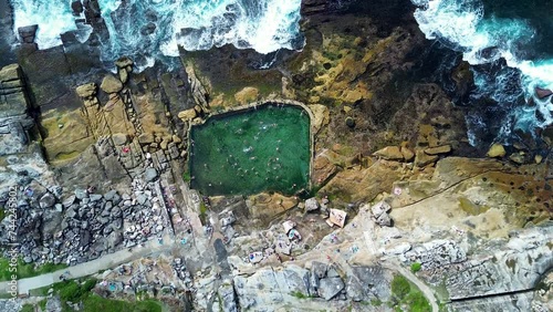 Drone aerial people swimming in Mahon rock pool bath Maroubra beach rocky ocean headland Randwick Sydney city travel tourism Australia