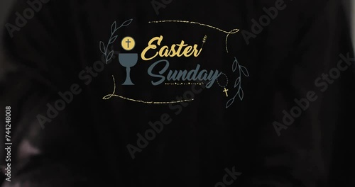 Animation of eastersunday text with biracial woman's hands on black background photo