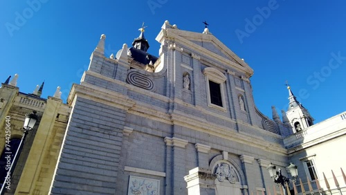 looking upward to Catedral De La Almudena huge church in city center of Madrid catholic monument on blue sky daytime photo