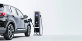 Electric Vehicle Plugged In and Charging at Modern Charging Station. Banner with copy space