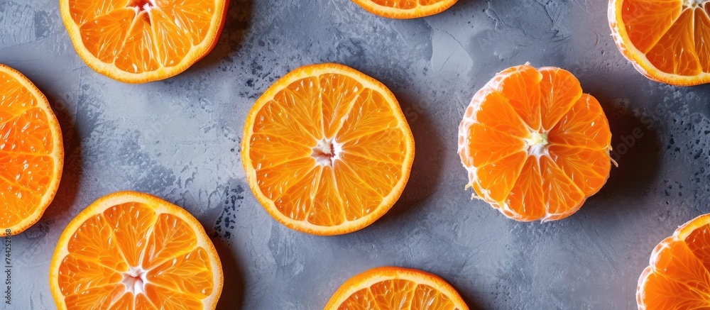 Several ripe oranges are placed neatly on a table, showcasing their vibrant colors against the plain background.
