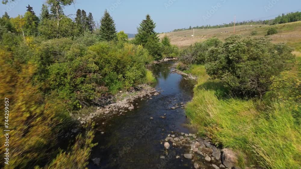 Aerial Drone Tracks Natural Stream Flow Along Cariboo Highway near 127 Mile House, British Columbia, Canada. Aerial Drone Tracks Natural Stream Flow Along Cariboo Highway near 127 Mile House, British Columbia, Canada.
