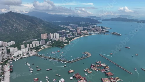 Aerial drone skyview of Castle Peak Road near Hong Kong Gold Coast Beach , So Kwun Wat, Tuen Mun, New Territories, is an idyllic convenient seaside and mountain area that includes a yacht club photo