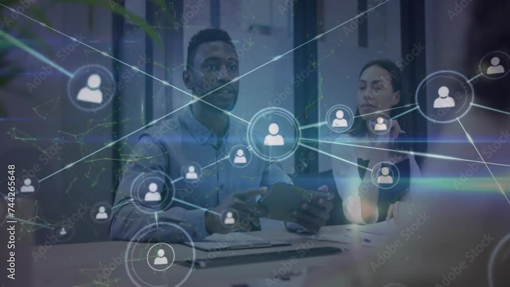 Animation of network of connections with icons over diverse business people in office Animation of network of connections with icons over diverse business people in office
