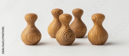 Three vintage wooden bowling pins set on a plain white background