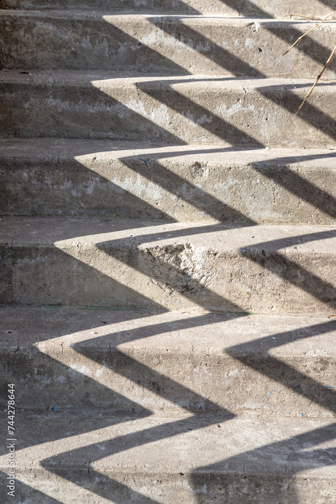 old concrete staircase with chevron pattern (created from the shadow of the hand rail
