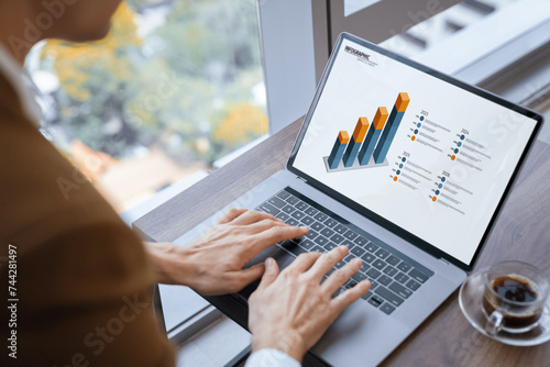 Top view of smart businessman hand searching, typing,analyzing data by using laptop. Closeup image of manager hand working with laptop displayed financial graph and business data. Closeup. Ornamented.