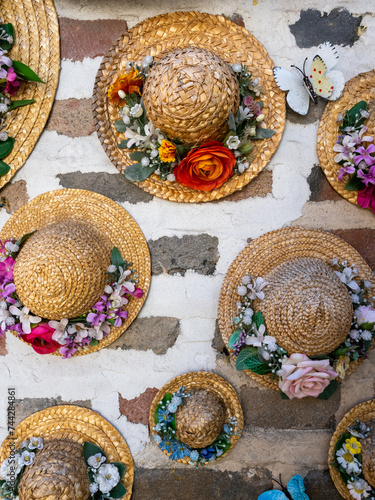 Straw hats with flowers decorating brick house walls in Ikseondong Hanok village - Seoul, South Korea