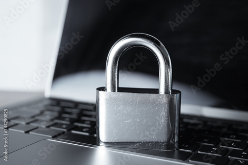 Cyber security. Padlock on laptop, closeup view
