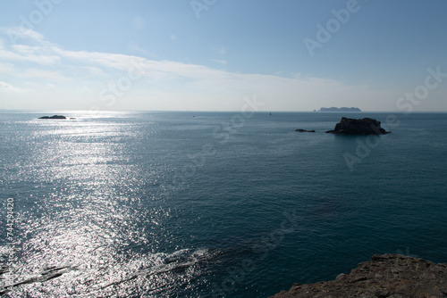 Seascape with rocks and horizon on a sunny day