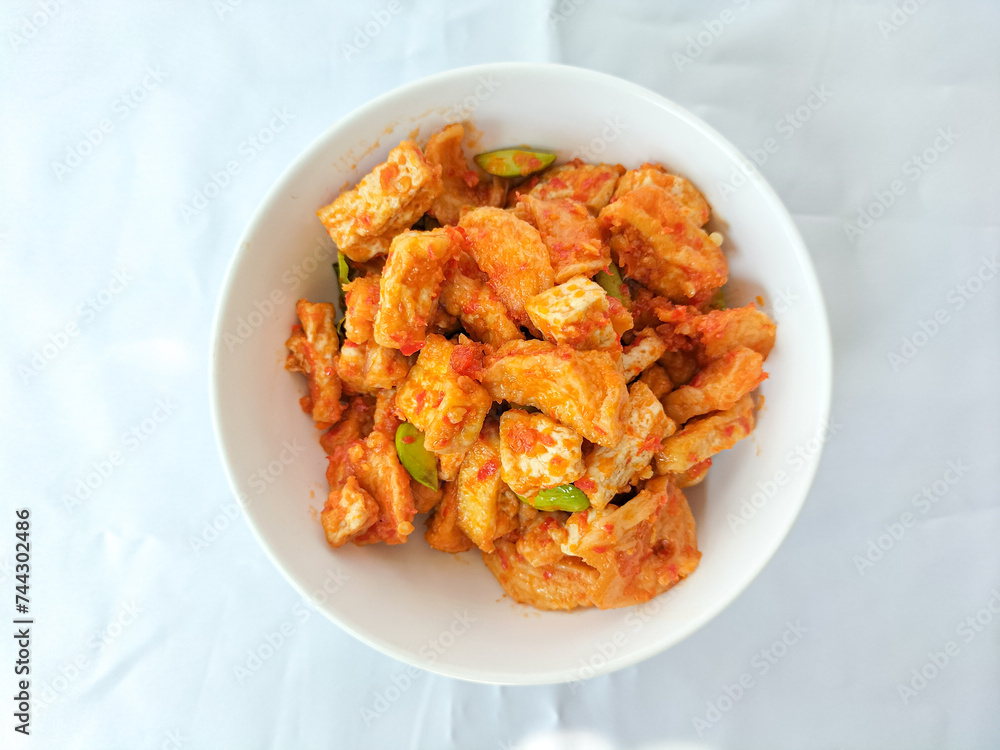 Selective focus. Tofu with balado Chili sauce served on a white bowl. Isolated white background. Yummy food.
Selective focus. Tofu with balado Chili sauce served on a white bowl. Isolated white background. Yummy food.