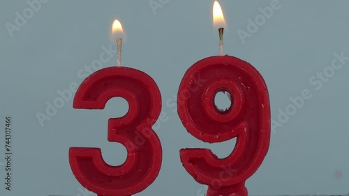 close up on a red number thirty ninth birthday candle on a white background.
 photo